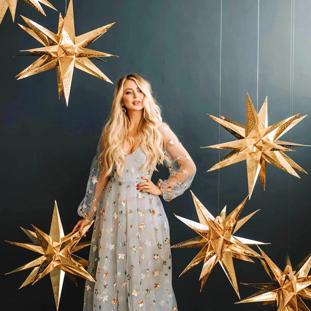 Gold Moravia Star Lanterns Hanging Around Woman