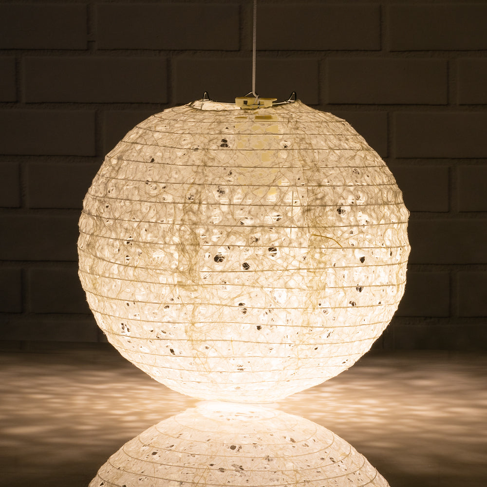 White paper lantern glowing warm white, lit from inside by a battery LED light kit